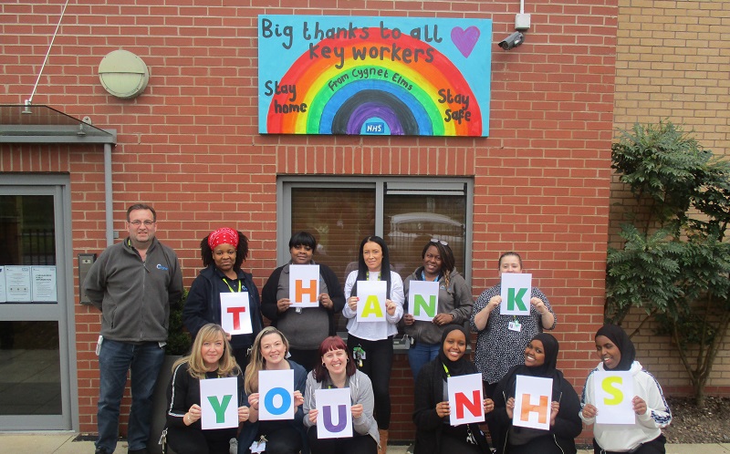 The Cygnet Elms team below their rainbow mural