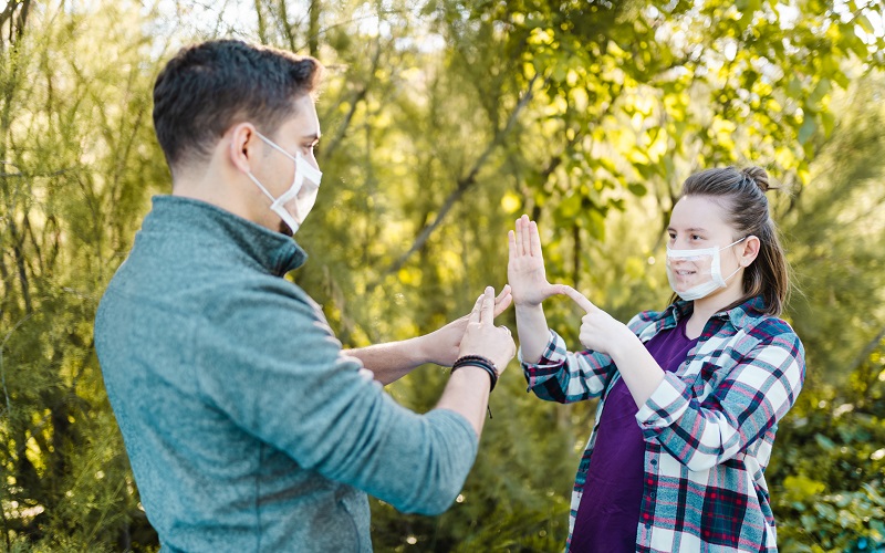 Deaf and hard hearing Young Adults wearing special face mask for lip-reading