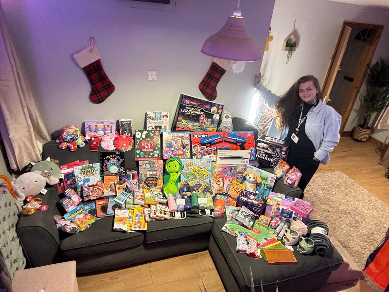 Carina with just some of the Christmas presents she has delivered.