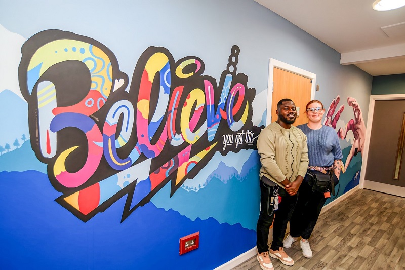 Support worker and muralist Wumi (Dare) Aduloju with Unicorn Ward Manager Vicky Higgins-Kay in front of the mural