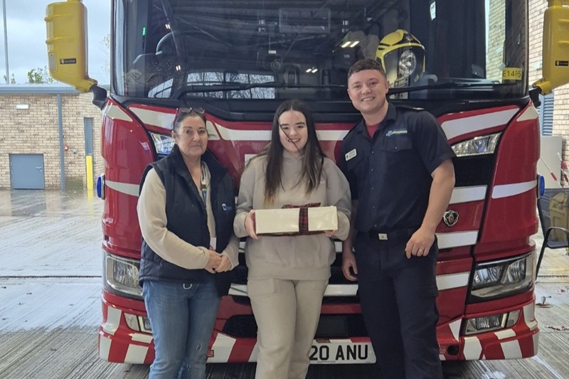 Cygnet Nield House patient and staff member delivering cakes to the local fire service.