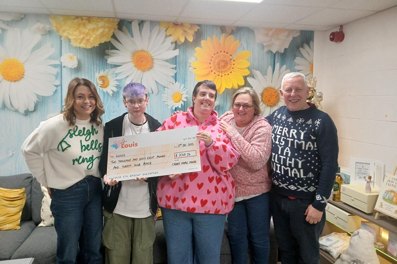 Staff and patients from Cygnet Maple House presenting a cheque to 4Louis