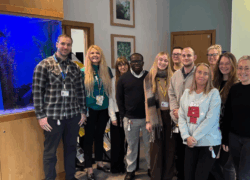A group of staff standing together inside Cygnet Oaks mental health hospital in Barnsley, marking the service’s achievement of the Carers Trust Triangle of Care accreditation. The team are pictured in a welcoming communal area.