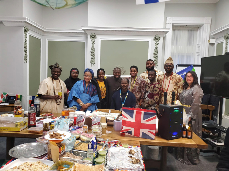 A diverse group of staff, patients and community partners at Cygnet Hospital Wyke celebrating Culture Day, with traditional dress, cultural food and shared displays representing different backgrounds.