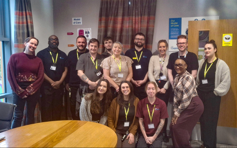 Staff from Cygnet Pindar House standing together indoors to celebrate receiving a ‘Good’ rating from Headway